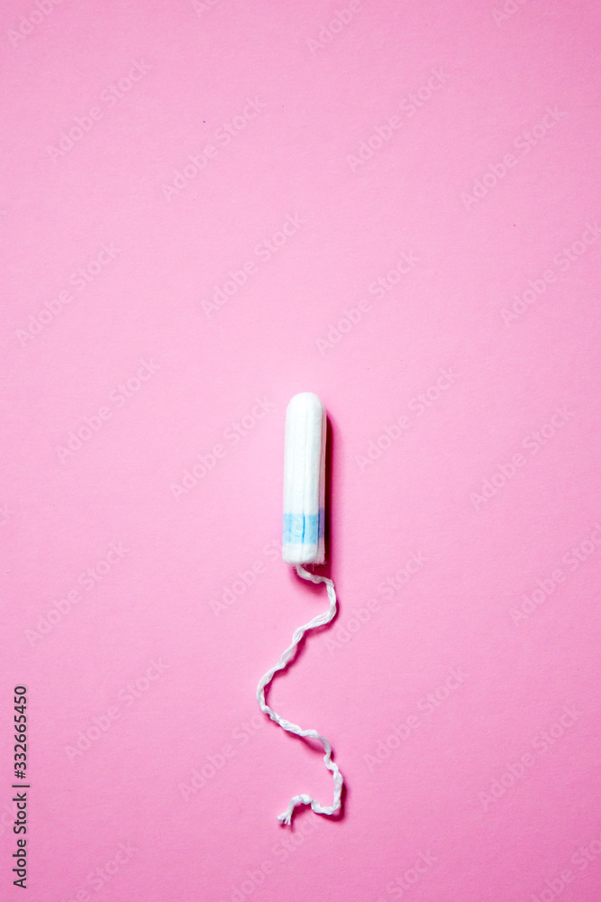 Medical female tampon on a pink background with copy space. Hygienic white tampon for women. Cotton swab. Menstruation, means of protection. Medical female tampon on a pink background with copy space. Hygienic white tampon for women. Cotton swab. Menstruation, means of protection.