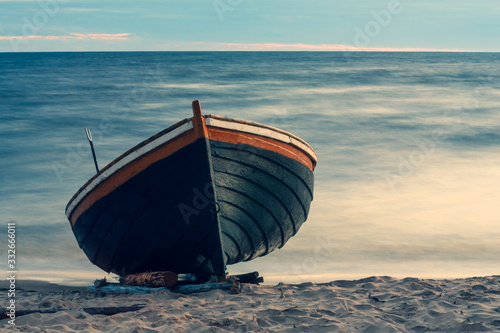 Fishing boat on the sandy beach of Latvia