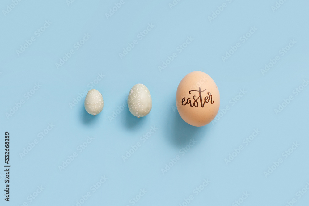 Egg with inscription EASTER over light blue background Egg with inscription EASTER over light blue background