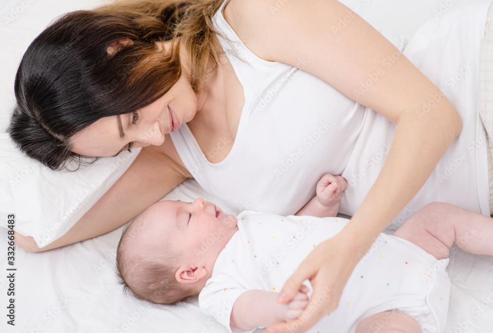 Mother and newborn baby sleeping in bed. Mother and newborn baby sleeping in bed.