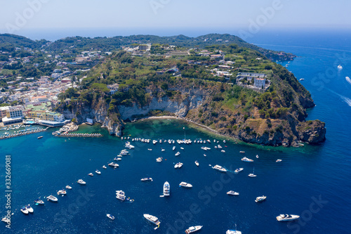 Aerial Drone photo of the beautiful island of ischia with blue sea and skies with hundreds of boats in Ischia, Italy
