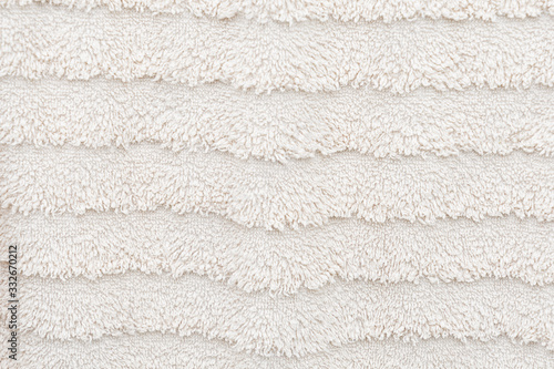 Texture of wool face towel in bright beige soft and fluffy