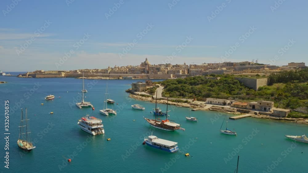Aerial view of Fort Manoel and Valletta - capital of Malta. Drone flights forward. Many boats on the Mediterranean see, green nature Aerial view of Fort Manoel and Valletta - capital of Malta. Drone flights forward. Many boats on the Mediterranean see, green nature