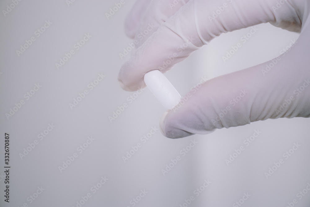 Medicine pills or capsules in hand, palm of a doctor or nurse. Drug prescription for treatment medication. Pharmaceutical medicament, cure in container for health. Antibiotic. Covid-19 coronavirus Medicine pills or capsules in hand, palm of a doctor or nurse. Drug prescription for treatment medication. Pharmaceutical medicament, cure in container for health. Antibiotic. Covid-19 coronavirus