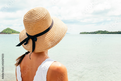 Woman in summer vacation enjoying the view at the ocean