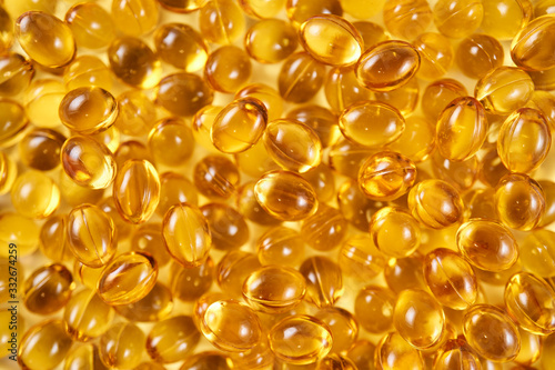 Closeup of a pile of vitamin D yellow pills (top view)