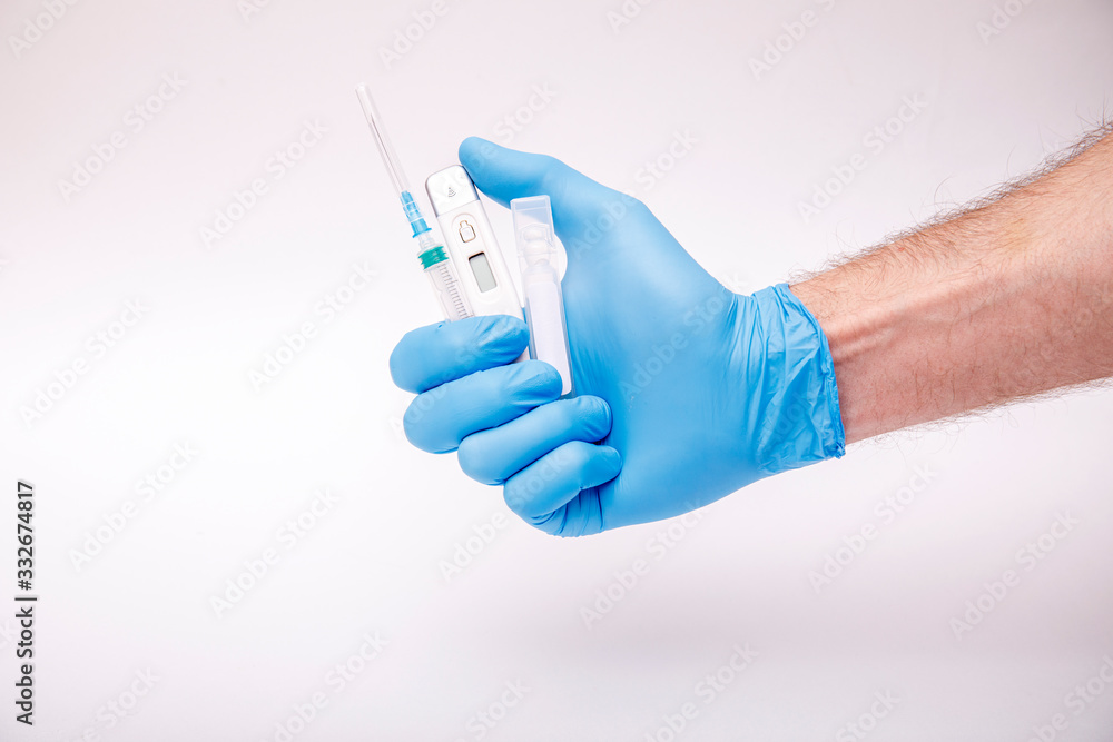 Thermometer on hand protected by blue gloves and medical face mask - equipment against corona virus. Covid-19 concept Thermometer on hand protected by blue gloves and medical face mask - equipment against corona virus. Covid-19 concept