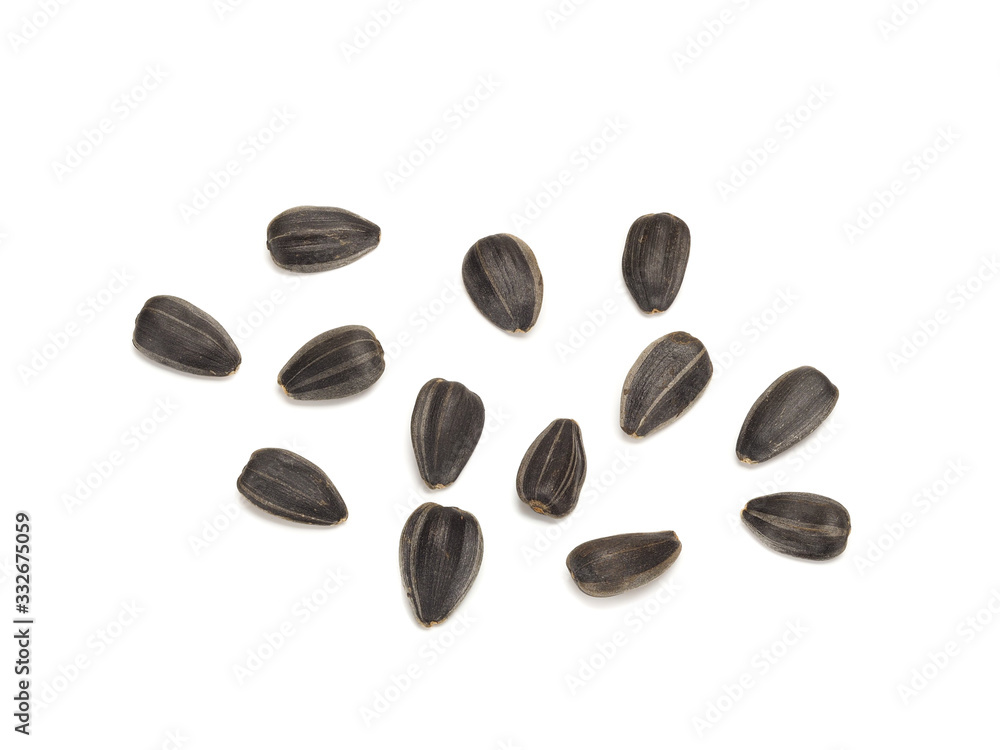 Obraz premium fried black sunflower seeds unpeeled, close-up on white background