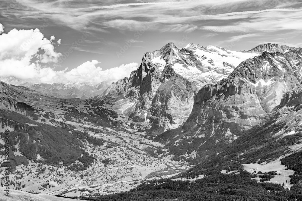 Obraz premium Switzerland, Panoramic view on Grindelwald valley and Wetterhorn and green Alps around