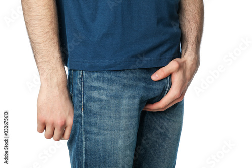 Man holding his groin, isolated on white background. Men's health