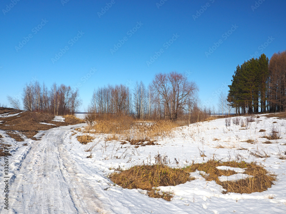 Spring Park, melting snow and ice. Trees. The river is under the ice. Russian spring nature. Russia, Ural, Perm Region Spring Park, melting snow and ice. Trees. The river is under the ice. Russian spring nature. Russia, Ural, Perm Region