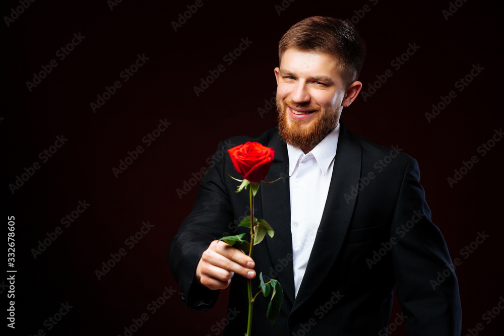 Handsome yound man smiling, getting ready for the date, holding red rose. Handsome yound man smiling, getting ready for the date, holding red rose.