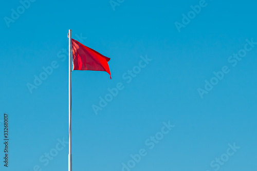 A red high-hazard beach warning flag in the sky