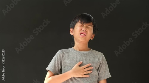4k young Asian boy feeling hurt at his heart