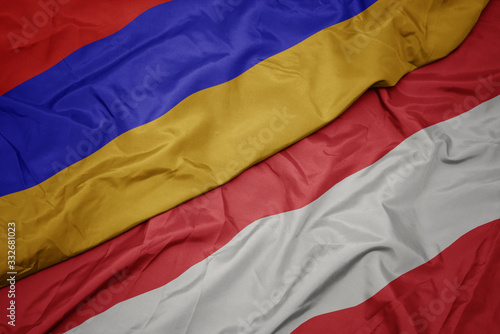 waving colorful flag of austria and national flag of armenia.