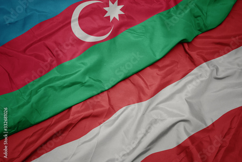 waving colorful flag of austria and national flag of azerbaijan.