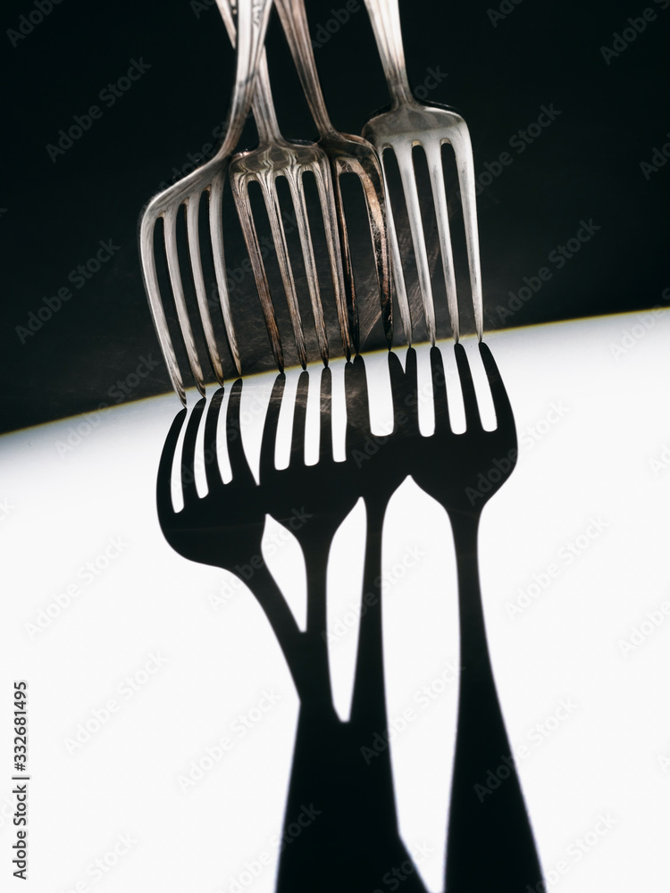 Forks dropping shadows on white Forks dropping shadows on white