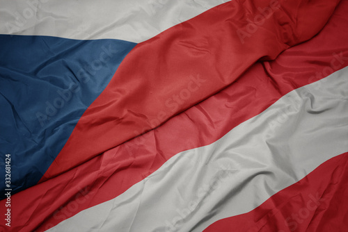 waving colorful flag of austria and national flag of czech republic.