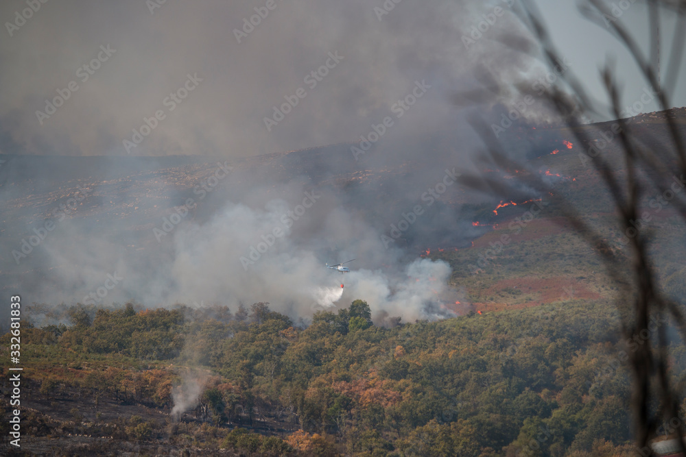 Helikopter vor Feuer und Qualm bei einem Waldbrand in Portugal im Sommer 2017 Helikopter vor Feuer und Qualm bei einem Waldbrand in Portugal im Sommer 2017