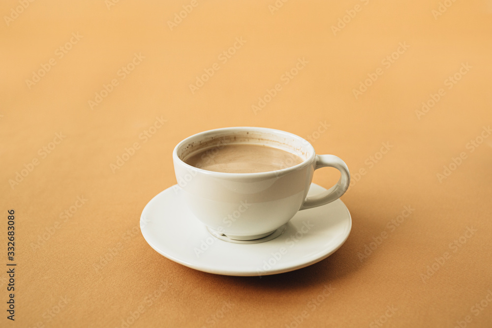 Cup of coffee with milk on ginger background. Cup of coffee with milk on ginger background.