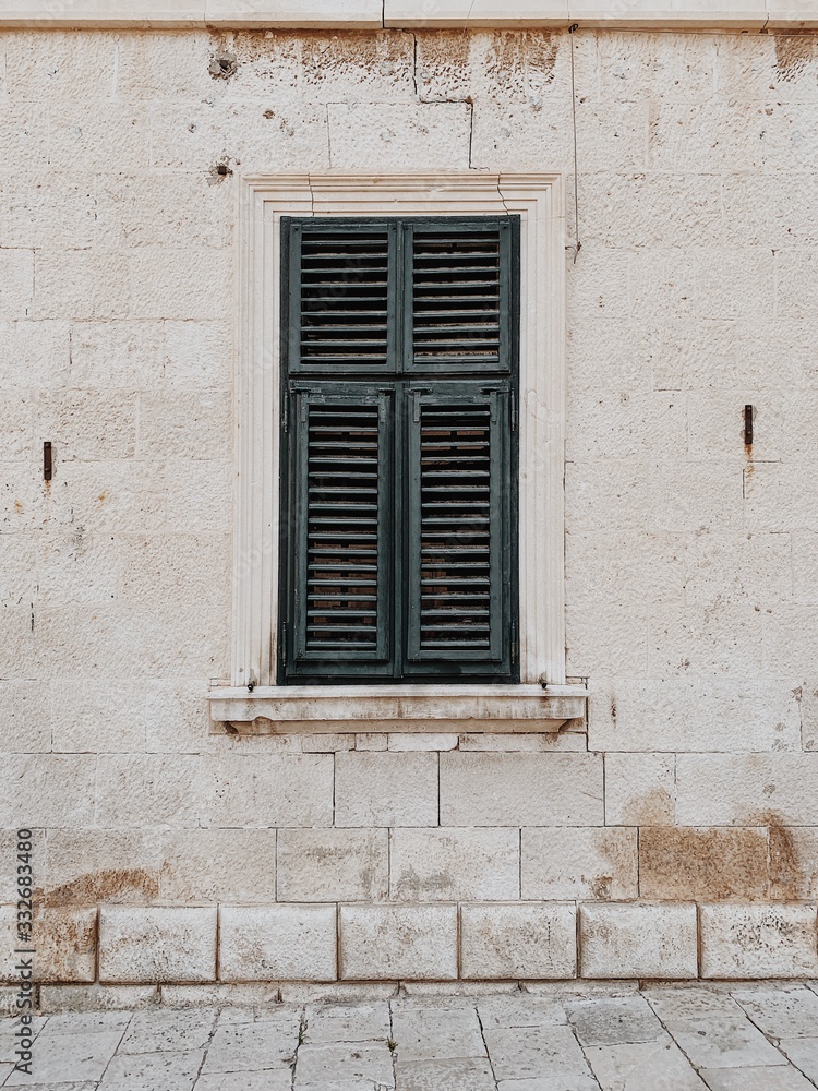 Minimal travel concept. Green wood shutters on old building. Front view. Old town and architecture in Europe,, Croatia, Dubrovnik. Minimal travel concept. Green wood shutters on old building. Front view. Old town and architecture in Europe,, Croatia, Dubrovnik.