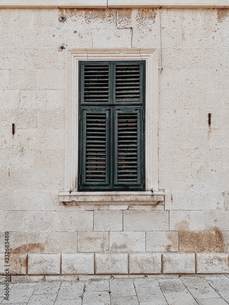 Minimal travel concept. Green wood shutters on old building. Front view. Old town and architecture in Europe,, Croatia, Dubrovnik.