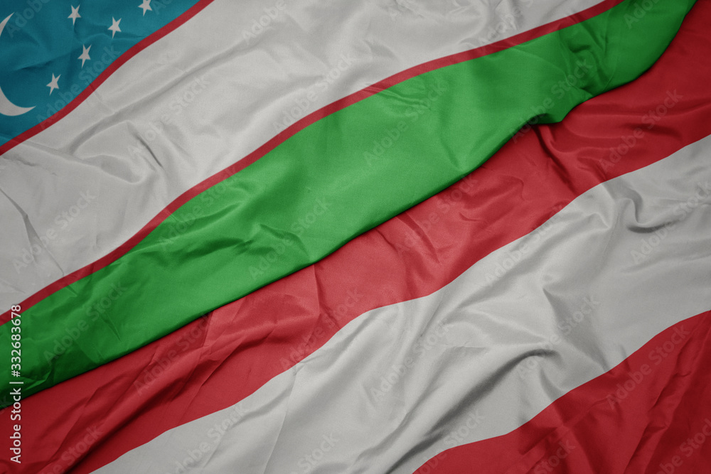 waving colorful flag of austria and national flag of uzbekistan.