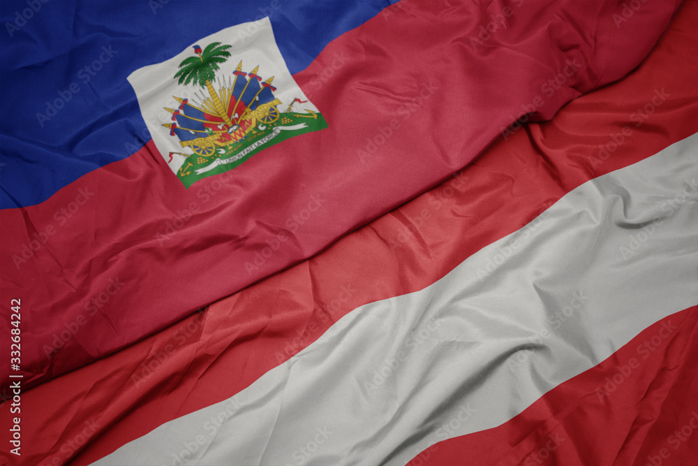 Fototapeta premium waving colorful flag of austria and national flag of haiti.