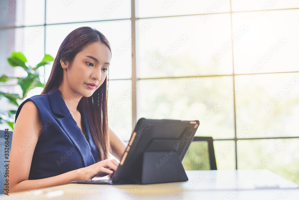 Happy attractive Asian business woman working with a laptop and financial document at office, successful action, Business concept. Happy attractive Asian business woman working with a laptop and financial document at office, successful action, Business concept.