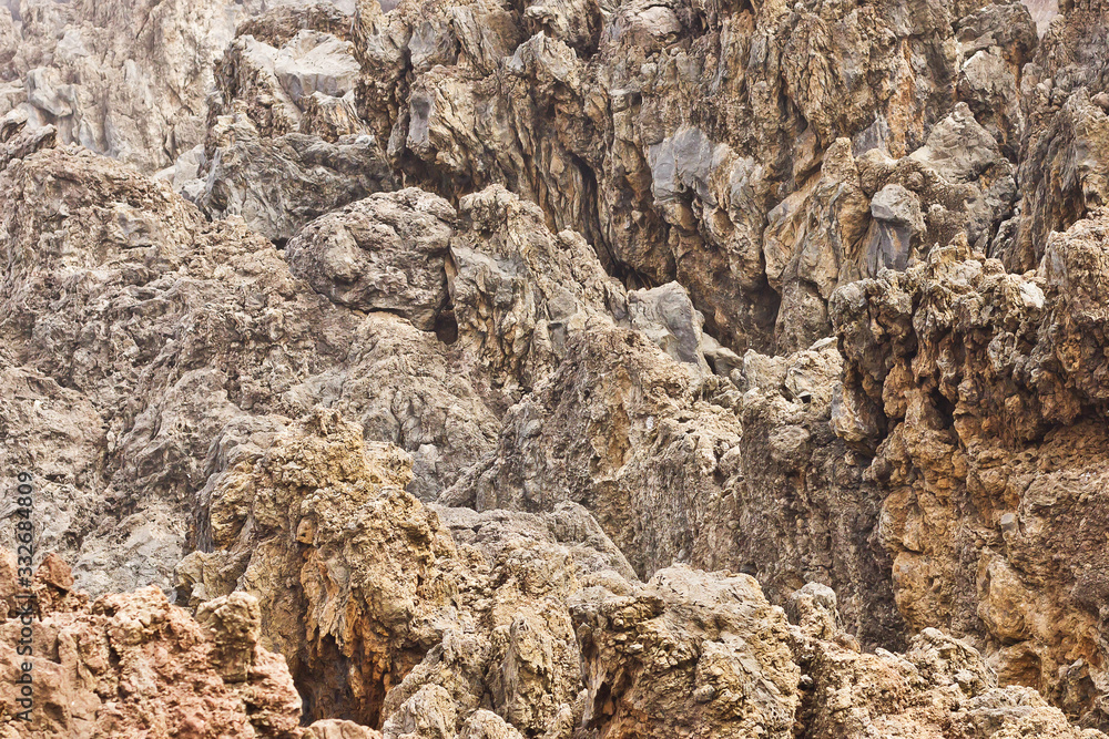 Madeira volcanic rocks. Porto Moniz geology texture. Lava stone cliff. Porous magma structure pattern.