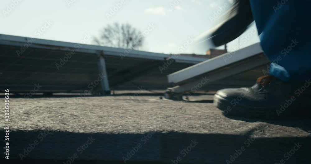 Person walking next to solar panels Person walking next to solar panels