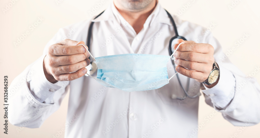 Doctor puts on or takes off his mask Doctor puts on or takes off his mask