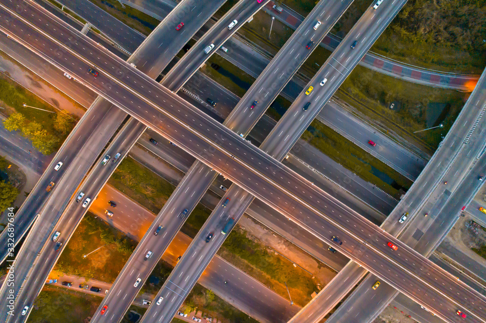 Obraz premium The light on the road roundabout at night and the city in Bangkok, Road beautiful Aerial View of Busy Intersection, Aerial view. Top view. Background scenic road.