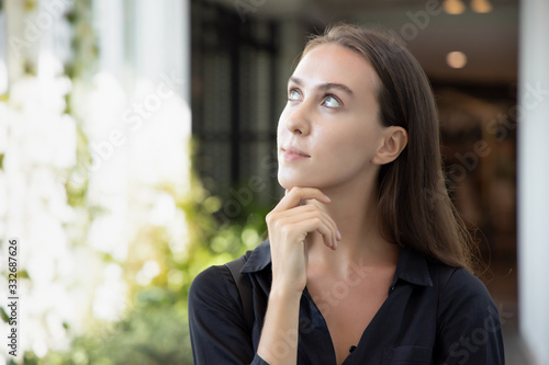 smart thoughtful white caucasian woman thinking, planning; portrait of asian woman looking up, thinking, finding good idea or decisive plan; adult Russian caucasian woman model