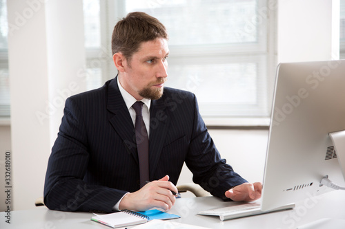 Young businessman working with computer at office