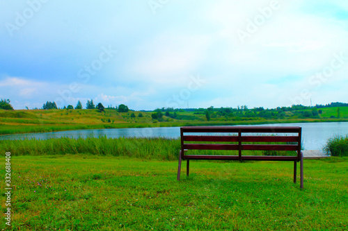 View of the summer lake and bench