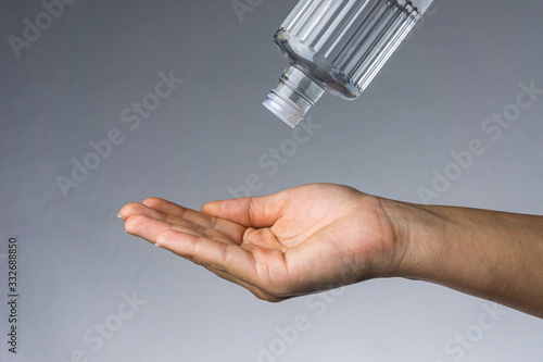 Woman applying Turkish disinfectant on her hand. Coronavirus transmission with a hands