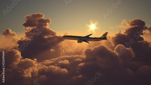 Airplane flying above the clouds on sunset photo