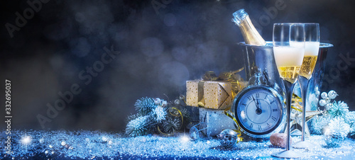 Sparkling New Year background. Champagne Explosion With Toast Of Flutes