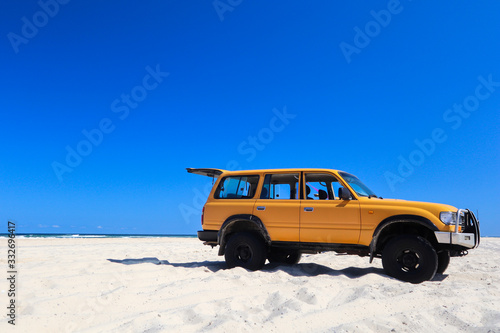 Four wheel drive parked on the sand by the beach