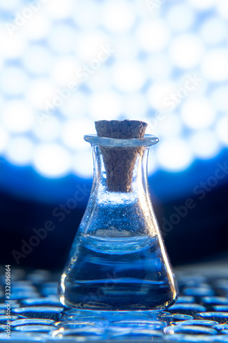 Test tube with color solution on blue laboratory background