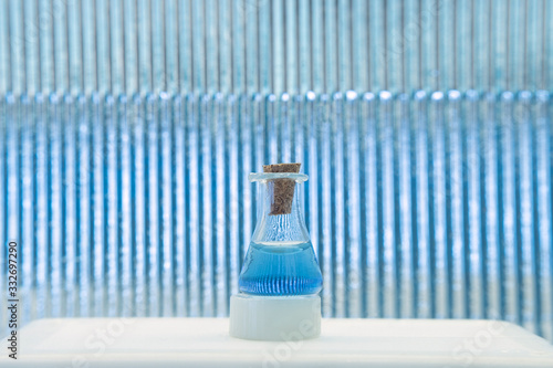 Test tube with color solution on blue laboratory background