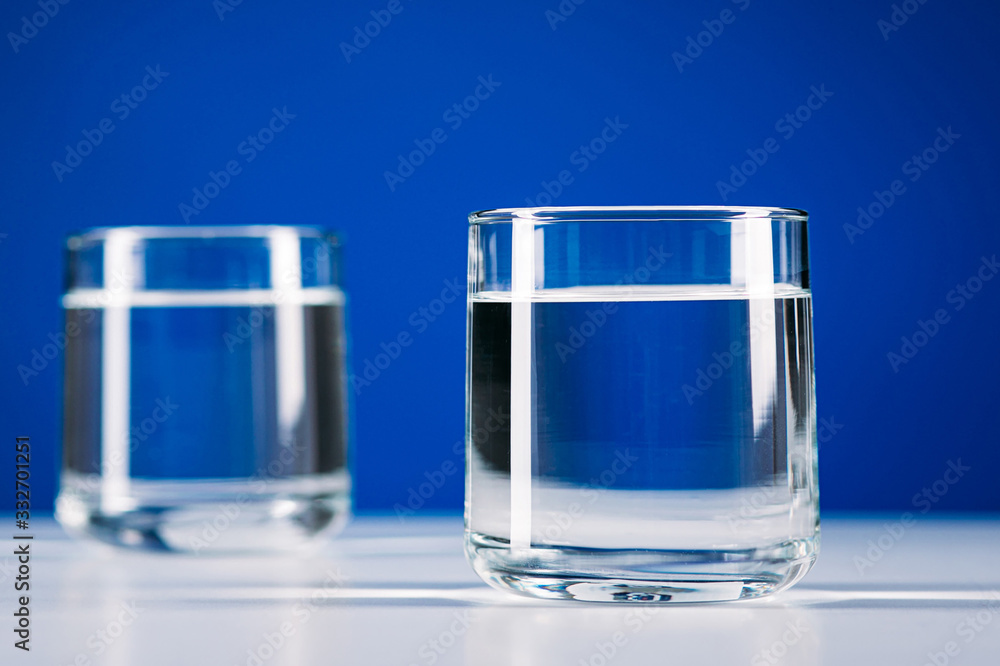 Two Glasses of water isolated on blue background Two Glasses of water isolated on blue background