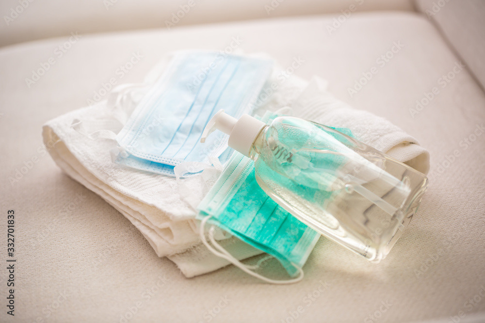Coronavirus prevention concept - Surgical travel masks hand disinfectant gel and and towel Coronavirus prevention concept - Surgical travel masks hand disinfectant gel and and towel