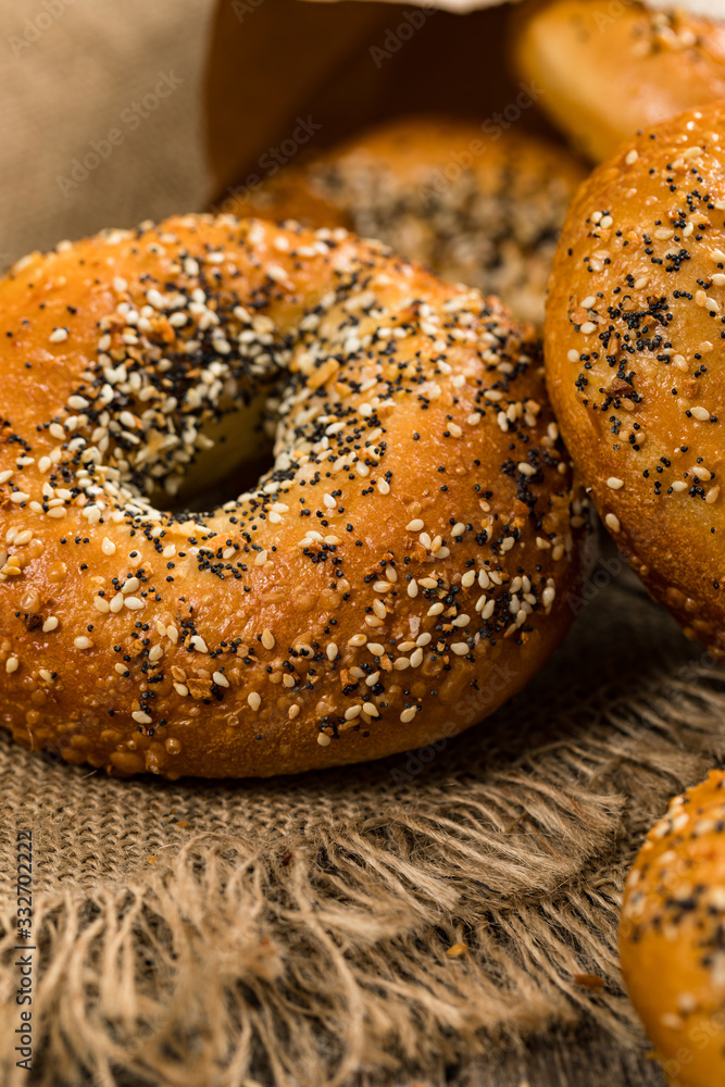 Freshly Baked Bagels Topped with Sesame Seeds, Poppyseeds, Garlic and Onion. Selective focus. Freshly Baked Bagels Topped with Sesame Seeds, Poppyseeds, Garlic and Onion. Selective focus.