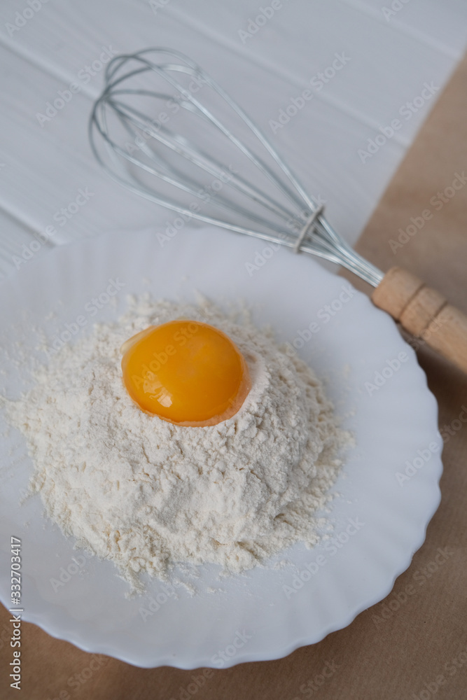 egg and flour on wooden table egg and flour on wooden table