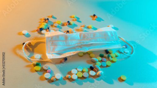 medical mask and pills on the table photo