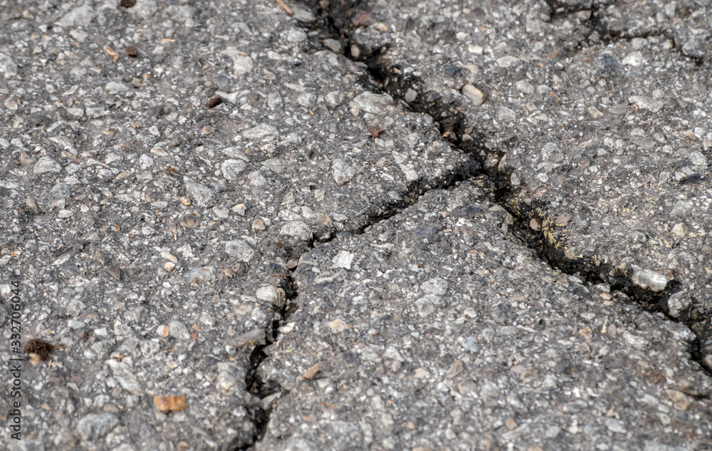 Time for road repair when the pavement begins to crack and crumble, Bokeh effect. Time for road repair when the pavement begins to crack and crumble, Bokeh effect.