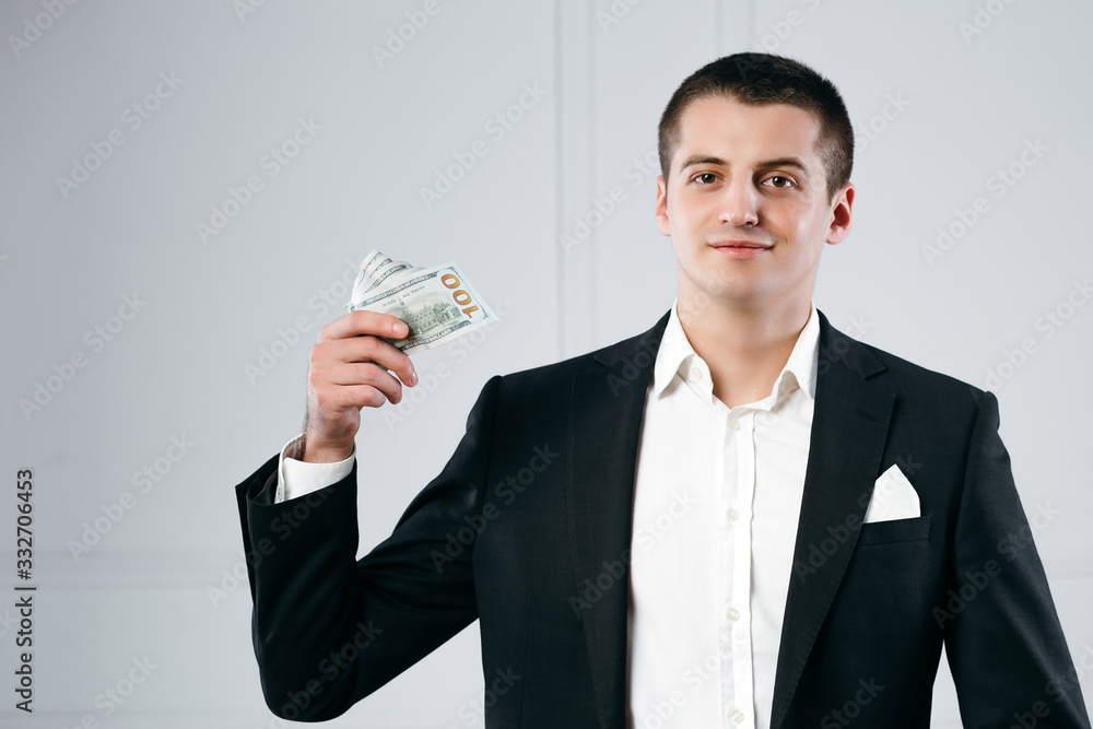 Portrait of a focused serious successful businessman holding money Portrait of a focused serious successful businessman holding money