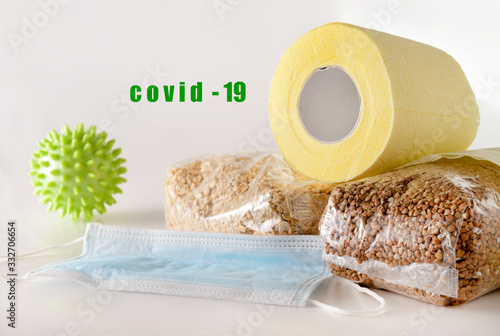 toilet paper, buckwheat, oat flakes, cereals, medical mask on a white , coronavirus, covit 19 photo